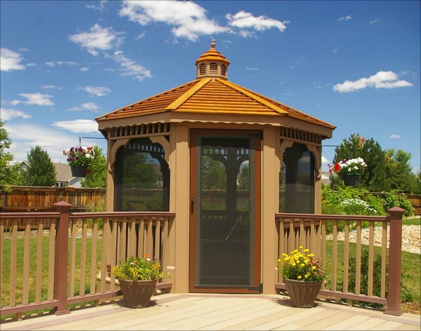 Fully enclosed wood gazebo built into the corner of a deck