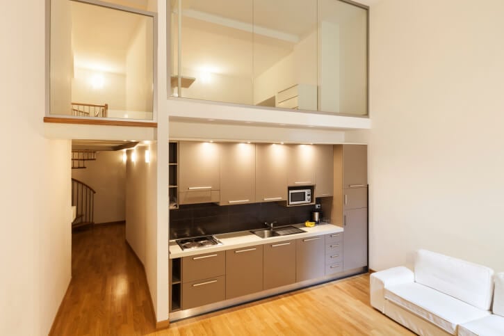 Tiny apartment with glassed-in loft above the kitchen and entry hall.