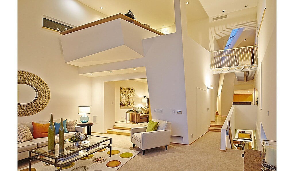 Intricate loft system where the loft space sits like a tray straddling two rooms on the main floor