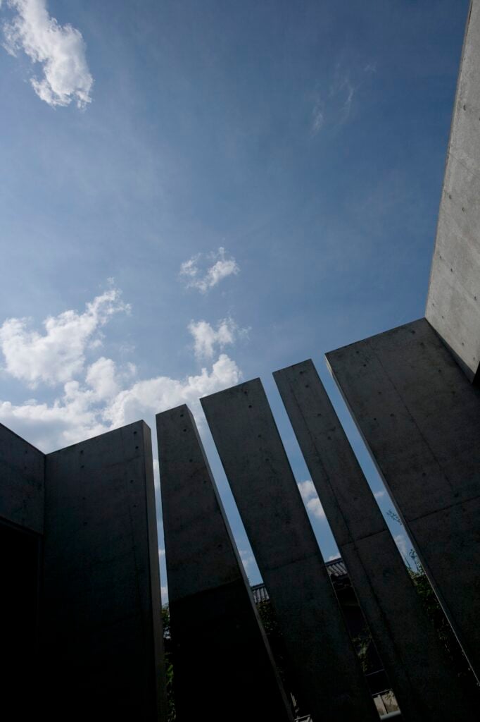 Another upward facing shot of the wall. The neighboring homes are barely visible through the slits.