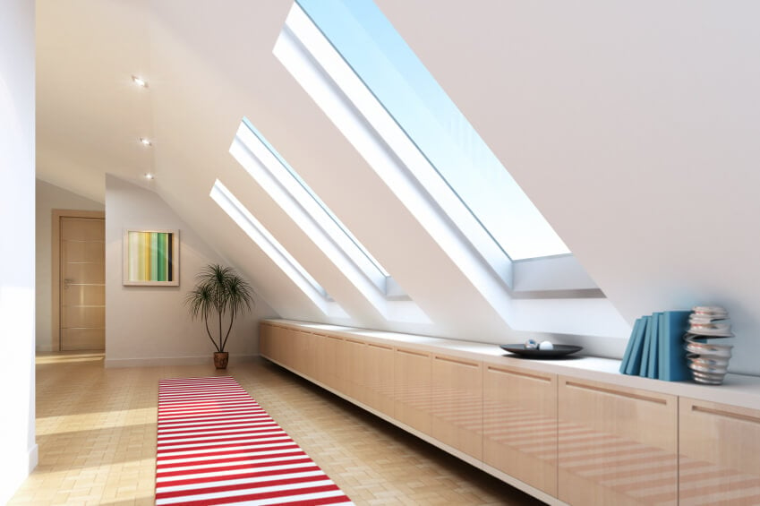 Attic room with cupboard storage and skylights