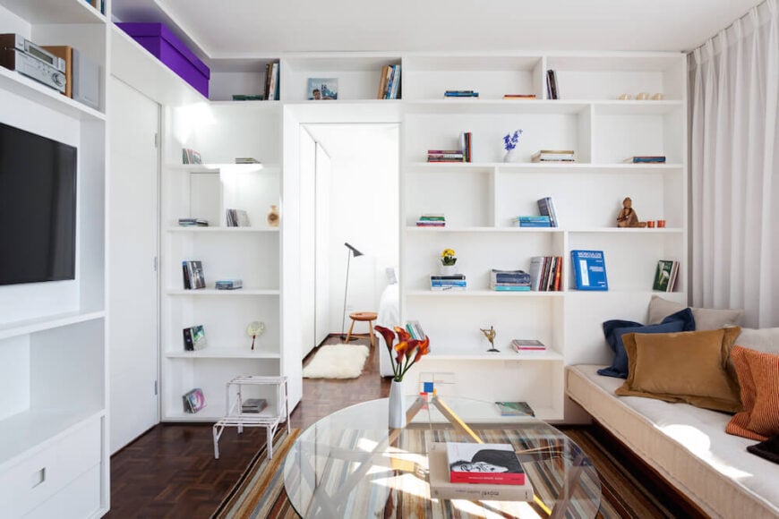 This beautiful home has a flowing set of shelves that move from the floor all the way along the ceiling. Despite the compacted space in the communal area, there is plenty of storage room.