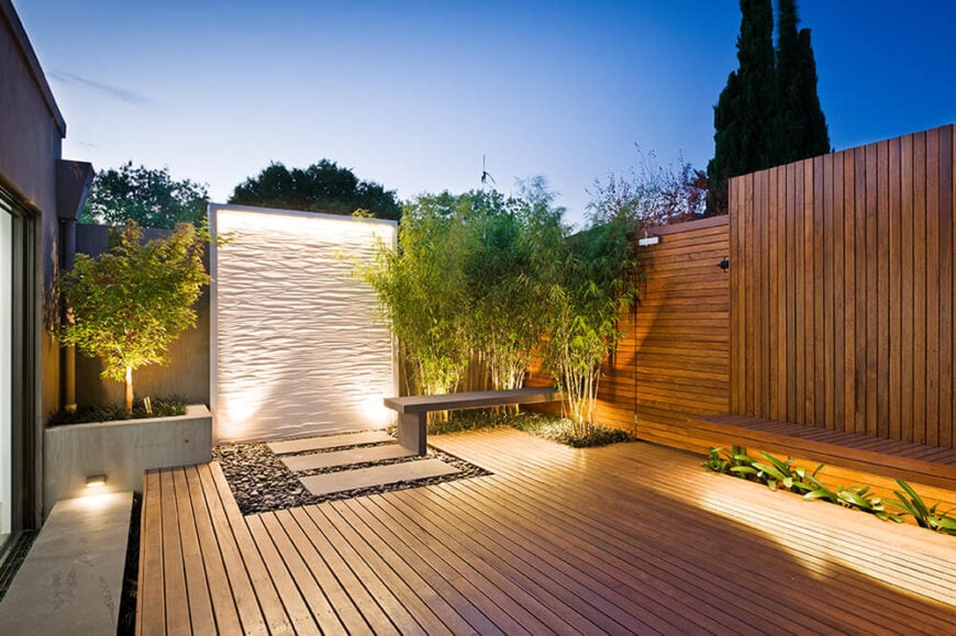 Here's another instance of bamboo cropping up in the landscape, punctuating an expanse of rich timber. At center is the exquisitely lit water wall by Lump, as well as the "floating" cantilevered bench, protruding from between bamboo fronds.