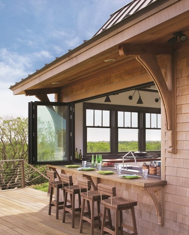 This home features a bar counter on the deck. The wooden bar stools match the deck.