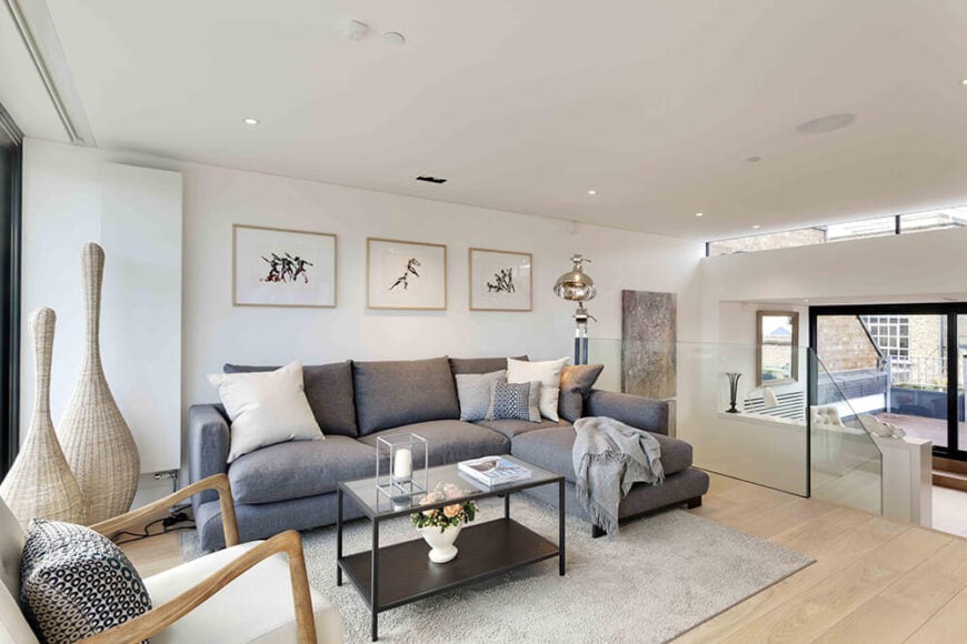 A simple glass balustrade separates the various levels in this open plan design, making for unbroken sight lines and an expansive sense of space in the relatively narrow home.