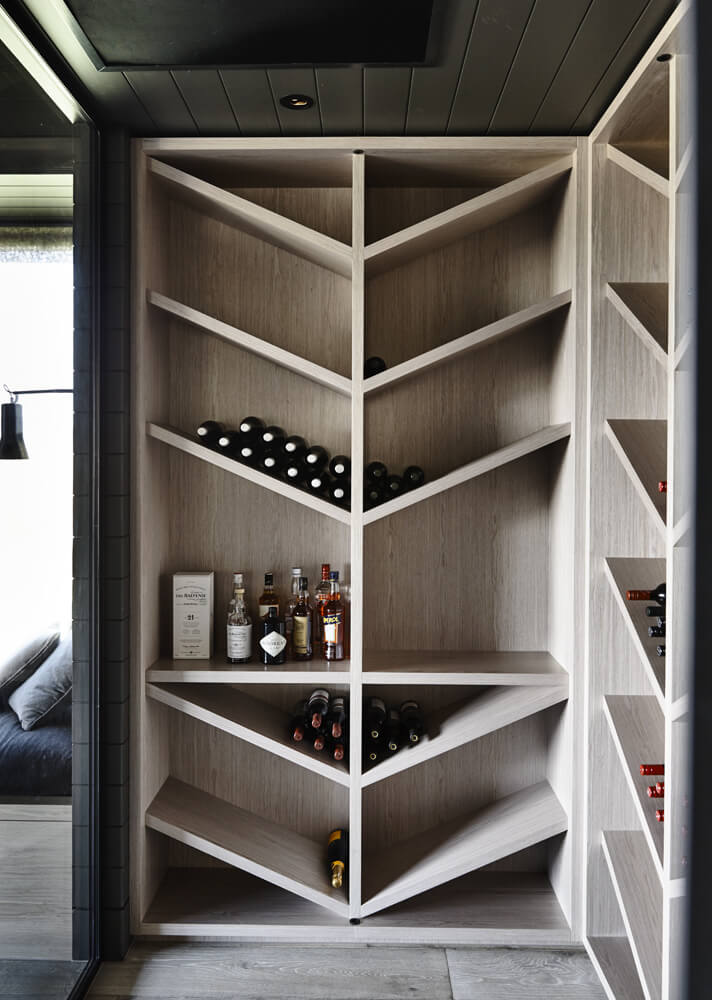 Tucked away is this unique angular wine cellar, a simple but bright corner of the home design that allows for bottles to be stored in an elegant and fashionable way.