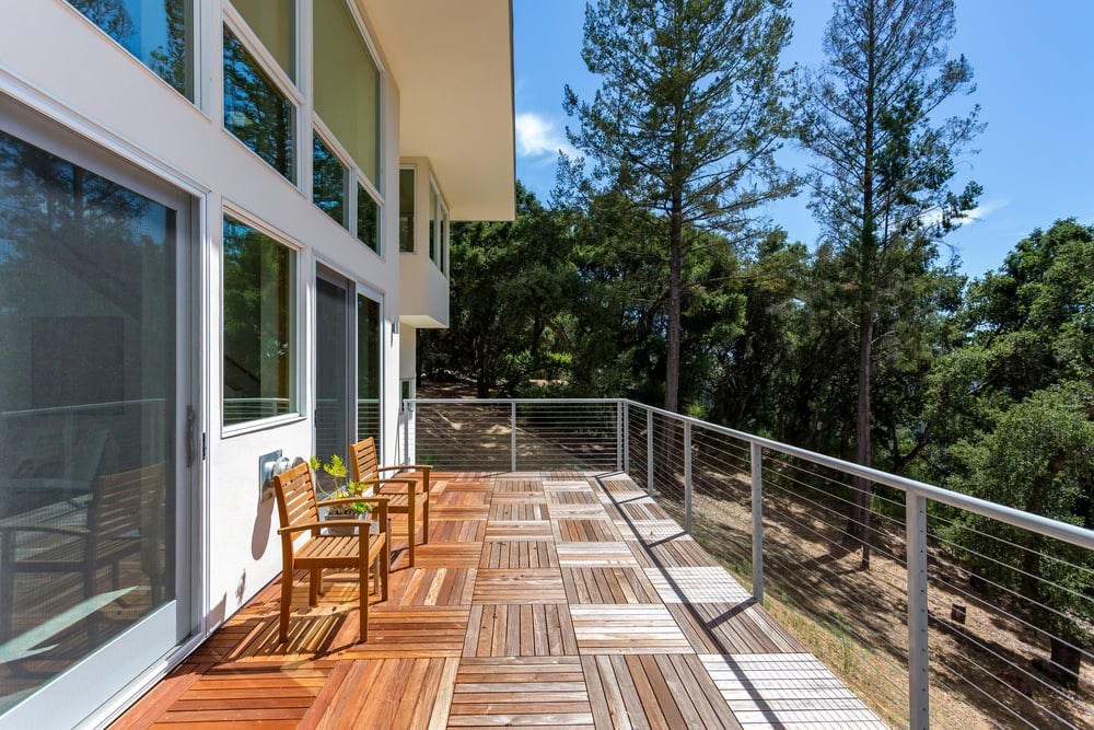 This deck offers a great view of the surrounding trees. The seats matches the flooring for a perfect look.