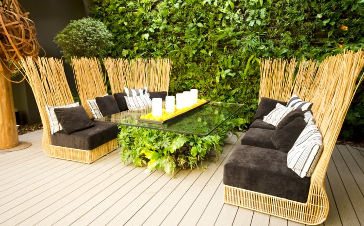 This deck offers a stylish and nature-friendly dining table set surrounded by beautiful greenery.