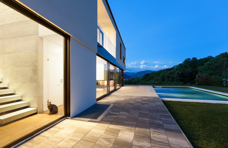 This mansion has a pressed concrete walkway leading to the garden area and swimming pool.