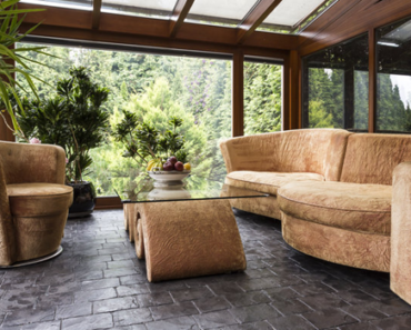 Sunroom and Conservatory room with beige sofa and graphite floor