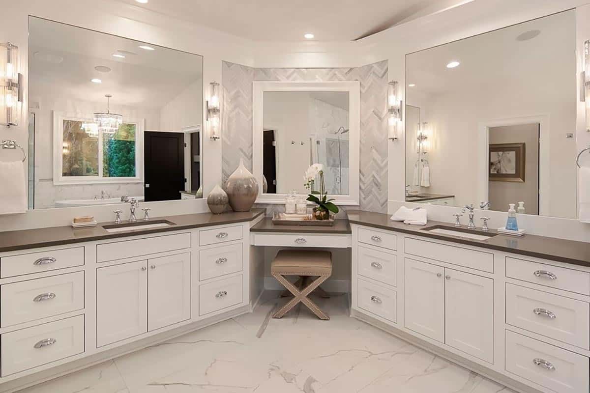 Primary bathroom with his and her sink vanities flanking the makeup counter.