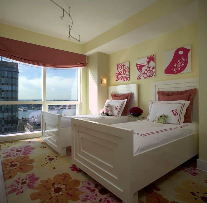 Contemporary kids' bedroom with twin beds and red floral motifs.