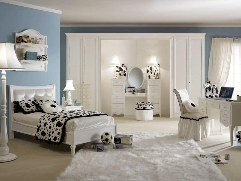 Large girl's bedroom with black and white accent all over the space. The carpet flooring looks classy. There's a powder space and a study area in the room.