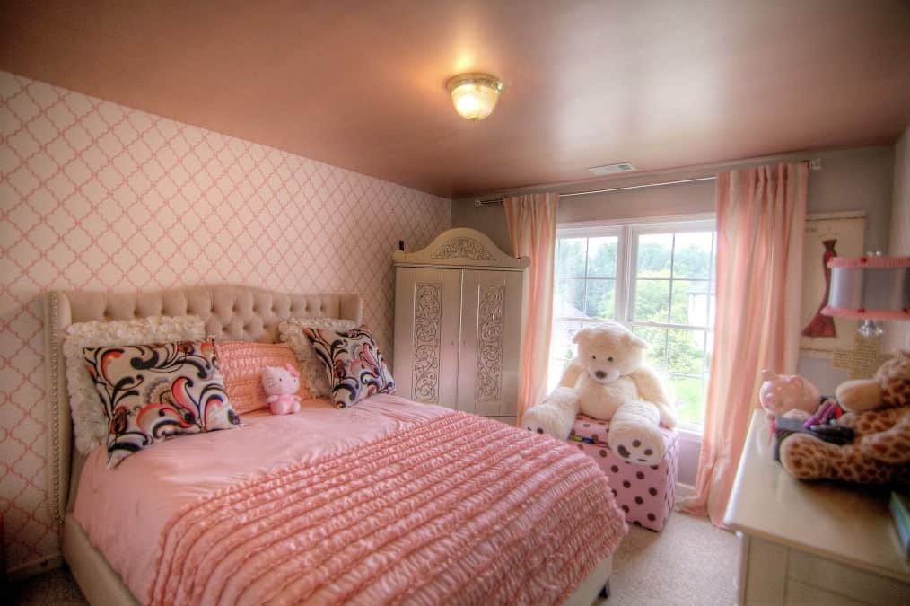 This girl's bedroom is surrounded by pink colors all over the place. The large stuffed toy served as a decor.