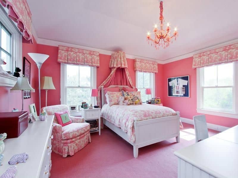 This girl's bedroom is surrounded by pink walls and floors, matching the lovely bed and seat. The room is lighted by a very charming chandelier.