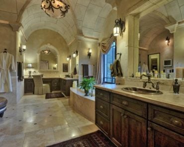 Large Traditional master bathroom with archway tile ceiling, wall sconces, drop-in tub and walk-in shower.