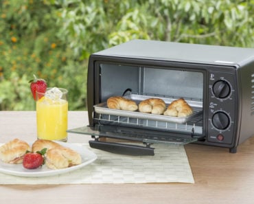 Small toaster oven on outdoor dining table.