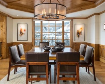 Craftsman dining room with chandelier and dome with beams ceiling.