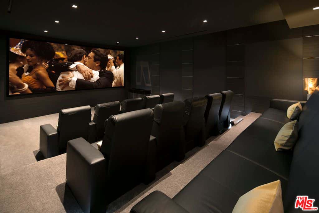 Contemporary living room with home theater, carpeted floor, and recessed lights.