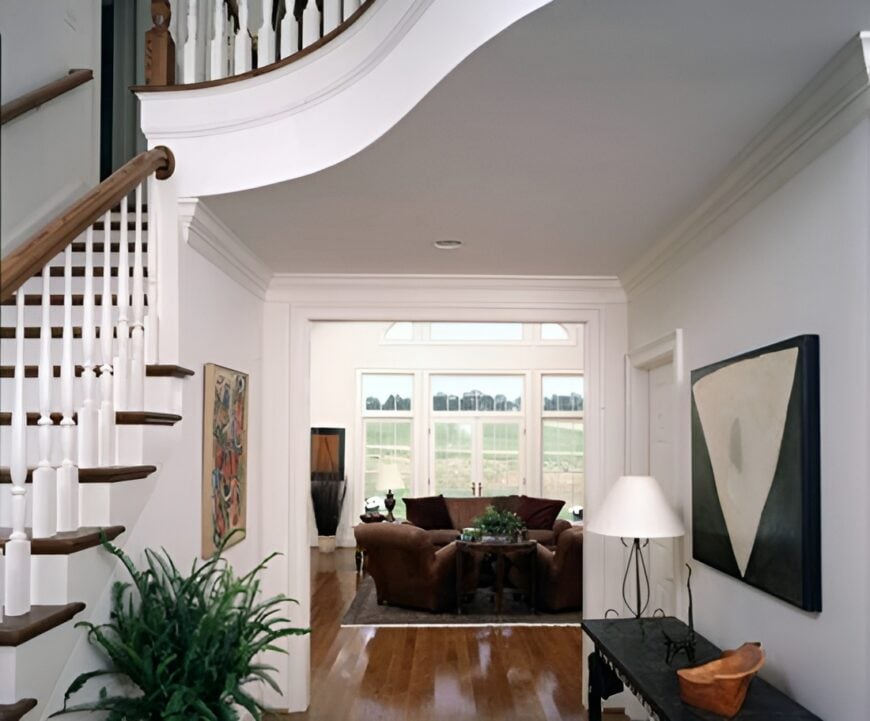 Foyer with a dark wood console table and a view of the family room.