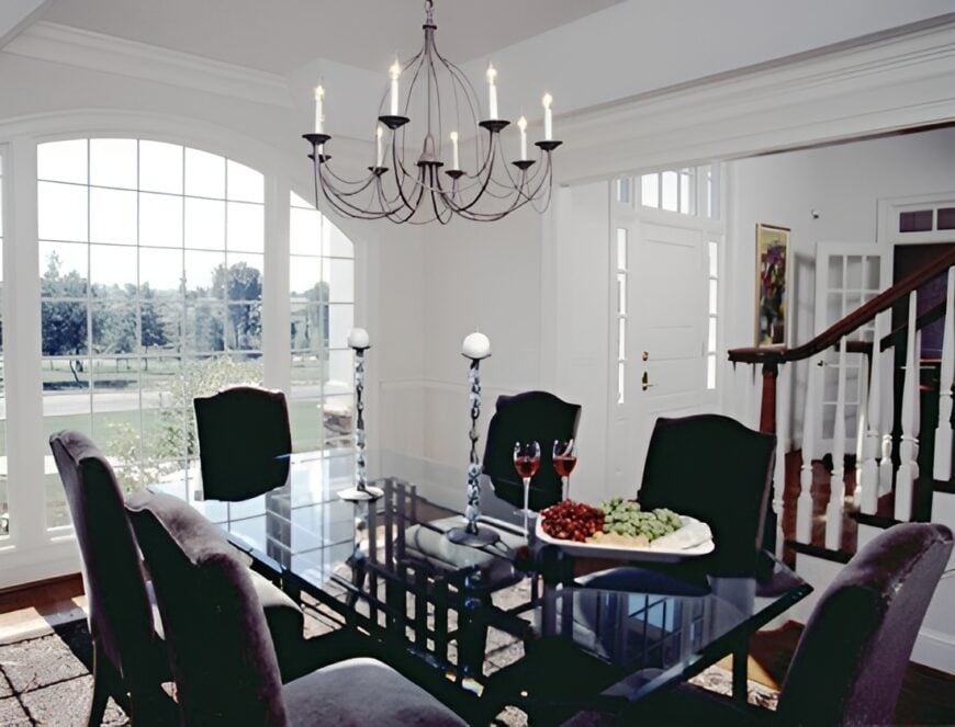 The formal dining room offers a 6-seater dining set illuminated with a candle chandelier.