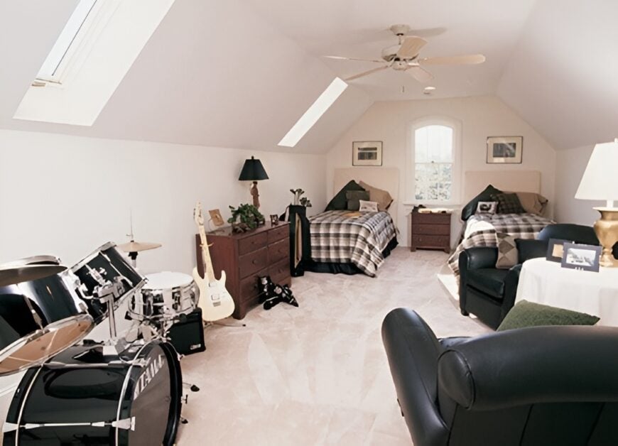 Bonus room with black leather seats, musical instruments, a couple of beds, and a coved ceiling fitted with skylight windows.