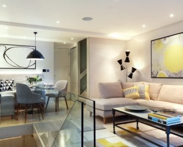 Contemporary living room with an elegant sofa set along with stylish lighting and wall decor. Photo credit: Alex Maguire