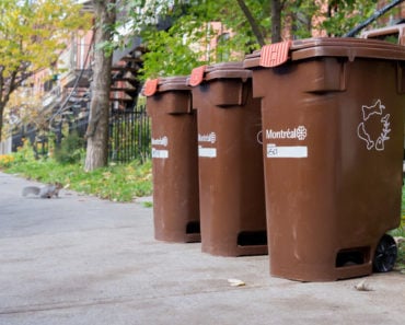 A set of three, brown composting bins for outdoor usage.