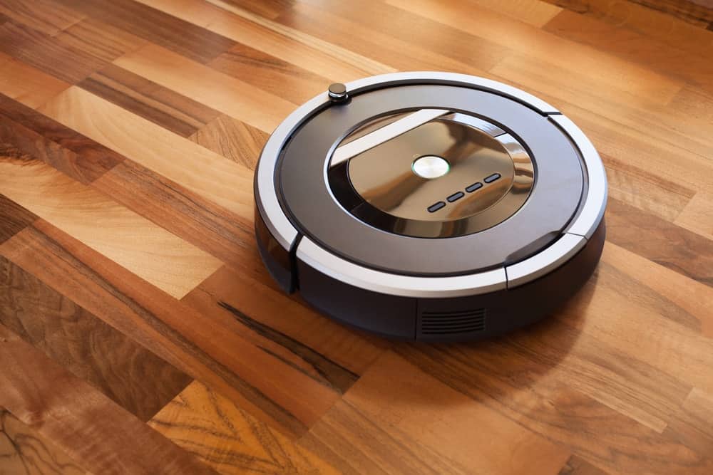 Robotic vacuum cleaner on laminate flooring.