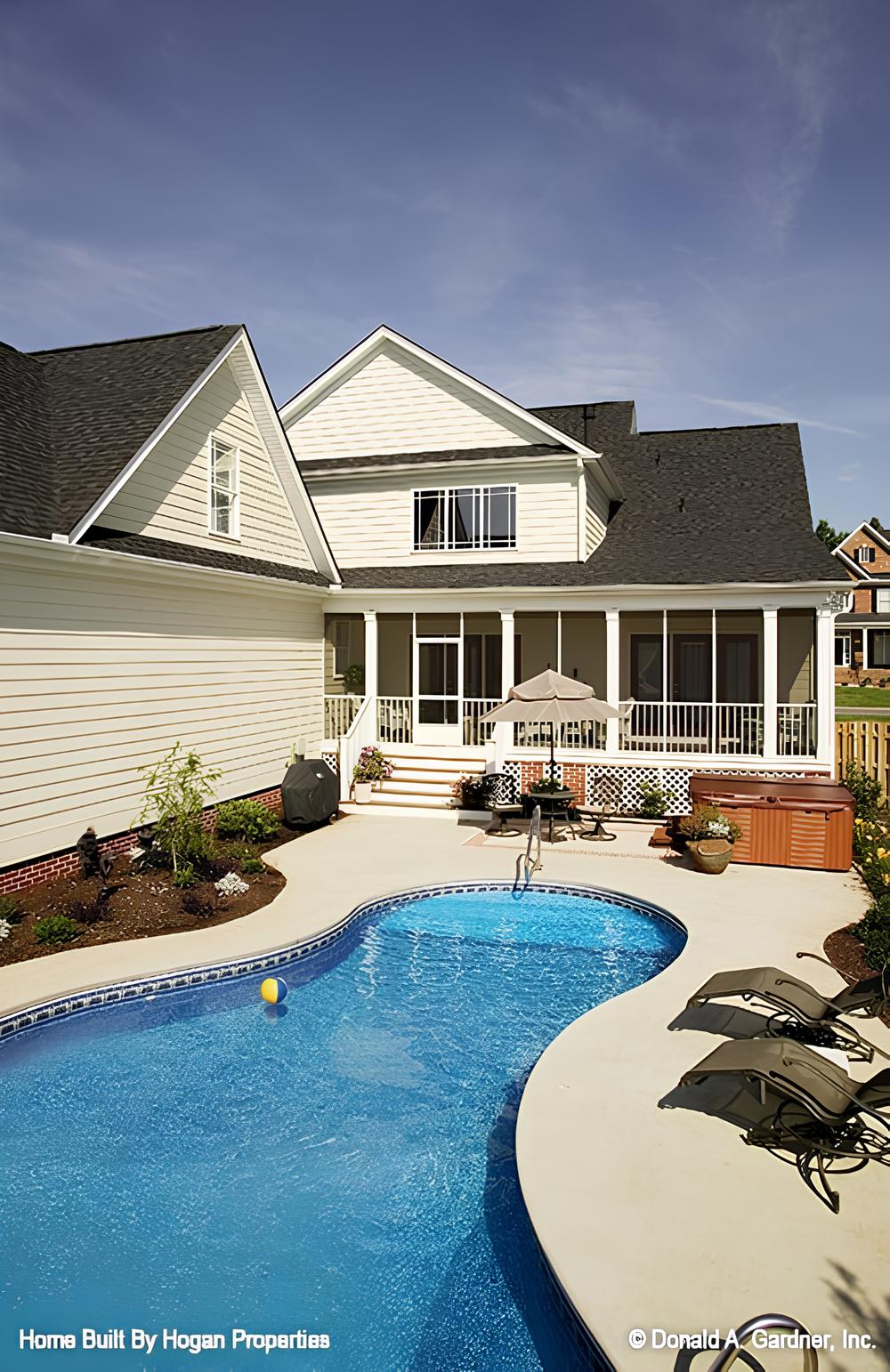 Rear exterior view with a covered porch and a swimming pool.