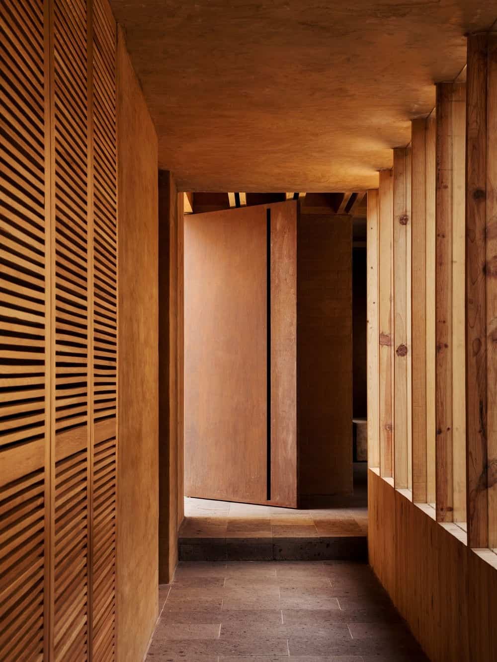 The hallway is surrounded by hardwood walls and ceiling.