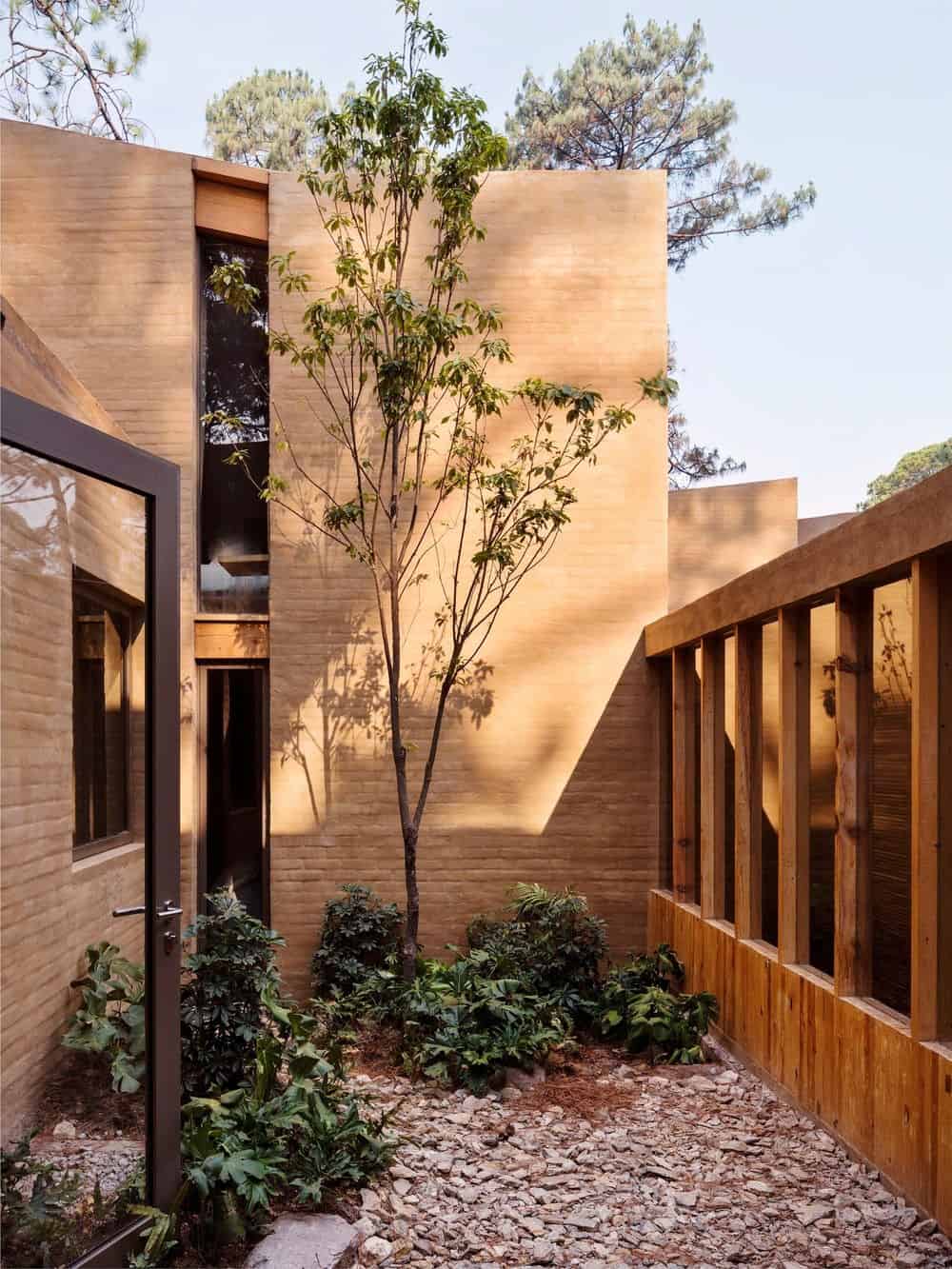 Another outdoor view of the house showcasing the beautiful landscaping.