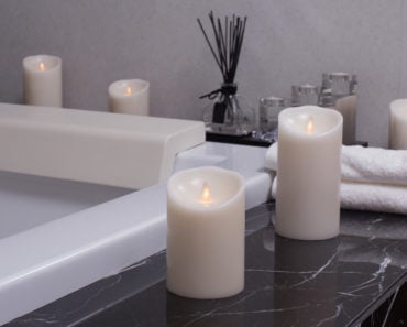 Flameless battery-powered candles on bathtub ledge