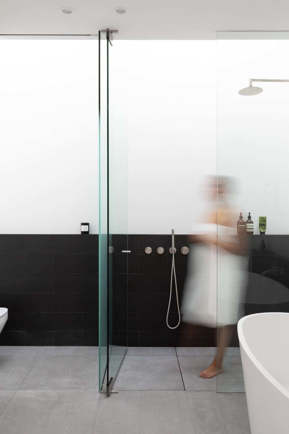 Another view of the bathroom focusing on its bathtub and shower area. Photo credit: Ema Peter