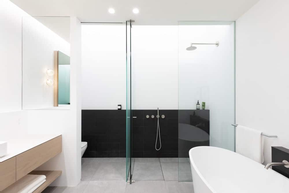The bathroom is complete with a shower area, bathtub and a sink area. Photo credit: Ema Peter