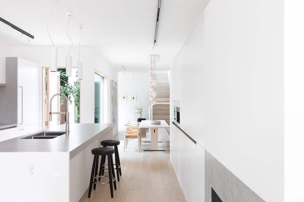 The kitchen features a large center island providing space for a breakfast bar. Photo credit: Ema Peter