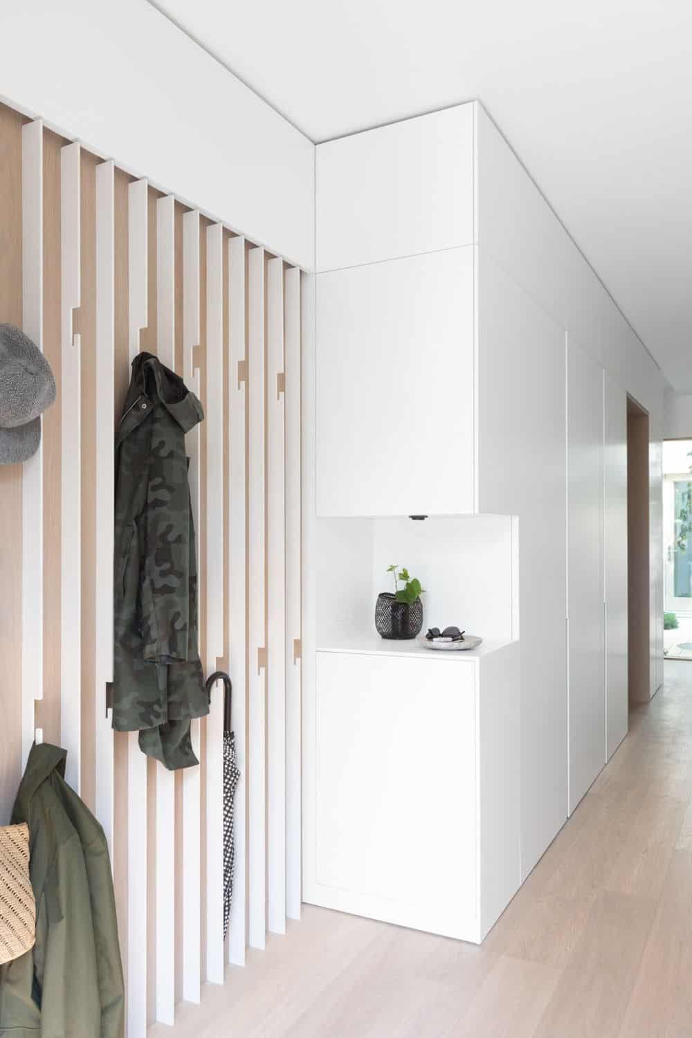 The house's entry features vinyl flooring and white walls. Photo credit: Ema Peter