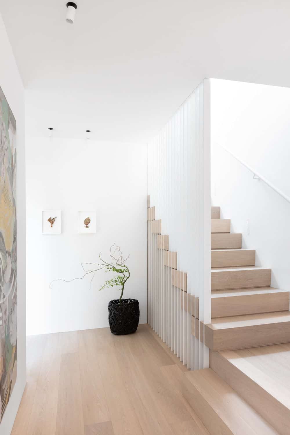 Hallway leading to other indoor amenities and a staircase leading to the home's second floor. Photo credit: Ema Peter