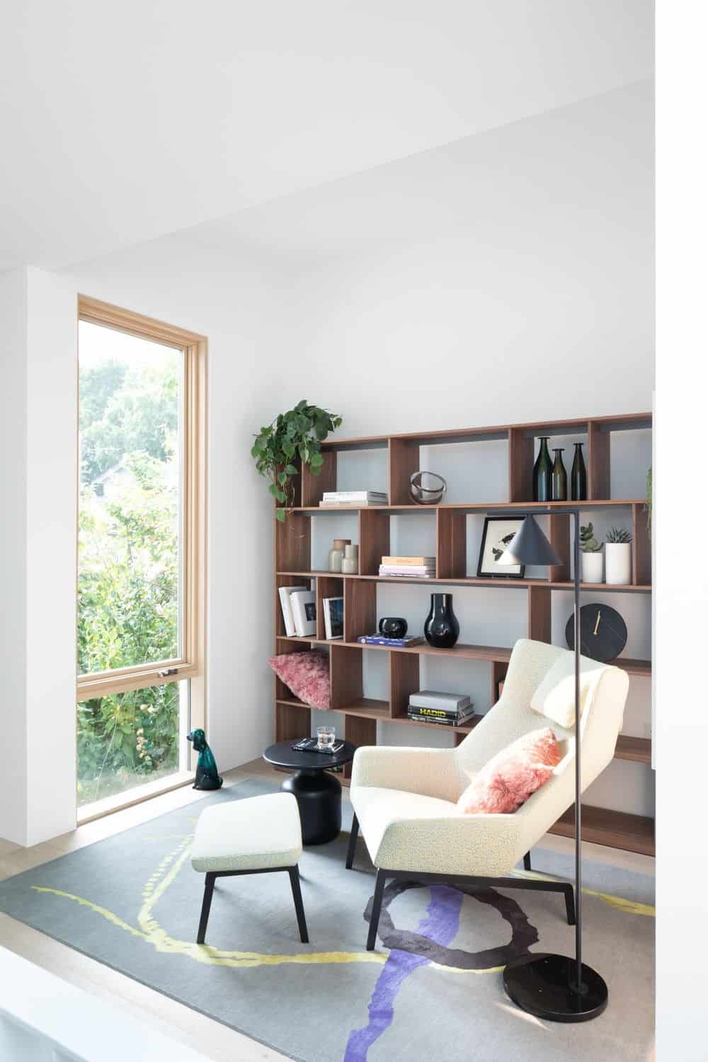 There's a reading area as well featuring a modish chair and multiple bookshelves. Photo credit: Ema Peter