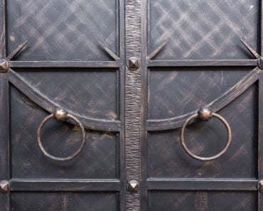 Wrought iron door with circular handles.