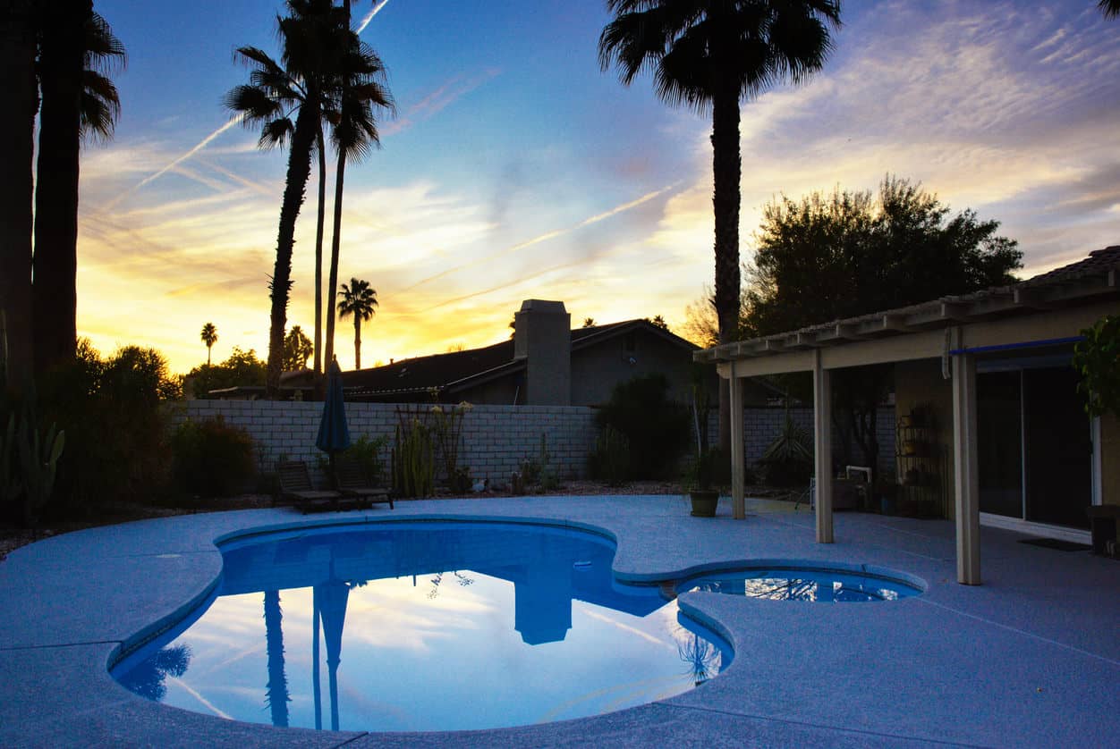 Here's a neat example of a small pool in a small suburban backyard. The entire backyard is pool and pool patio. It's very simple but looks great.