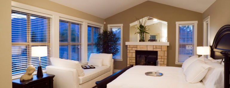 Gorgeous master bedroom with cathedral ceiling, divan, ceiling fan, lots of windows and beautiful bed.