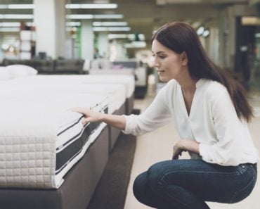 A lady is shopping for a new mattress.
