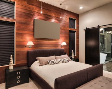 Modern master bedroom with wood accent wall and contemporary furniture