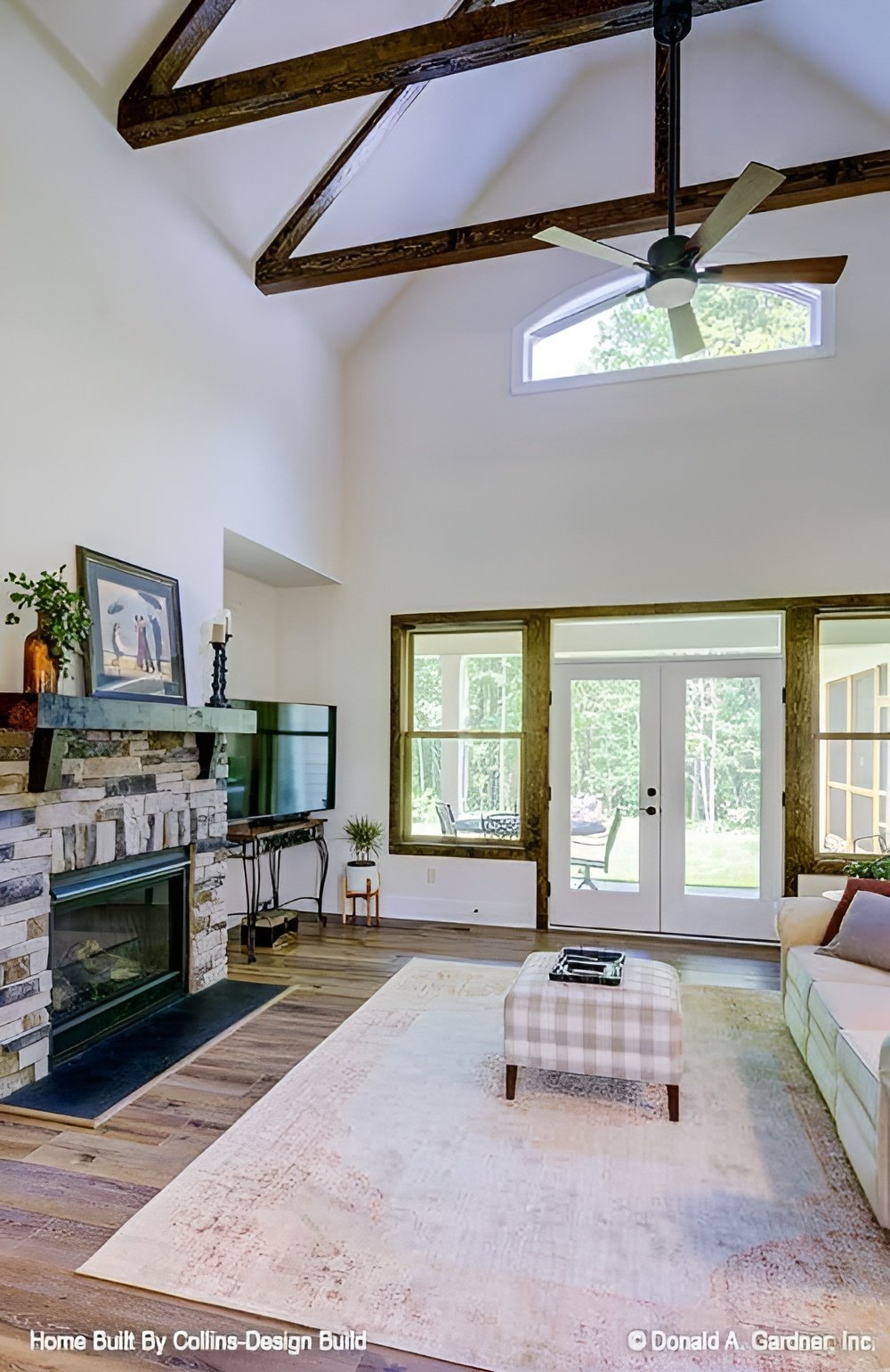 A cathedral ceiling framed with exposed trusses tops the great room.