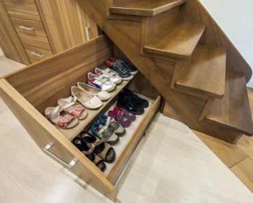 Stairs with storage drawers and shoe storage underneath.