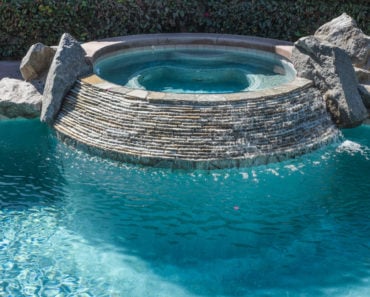 In-ground hot tub next to swimming pool
