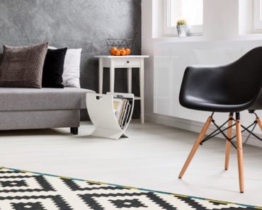 Living room with a modern white magazine rack on the floor
