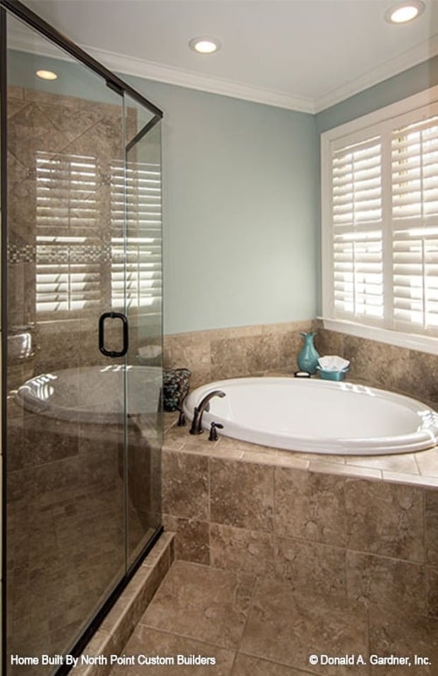 The primary bedroom features a tray ceiling and a bay window with a chaise lounge.