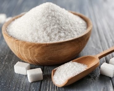 White Sugar in a bowl and spoon